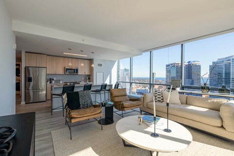 a living room with a view of the city and a couch and a table